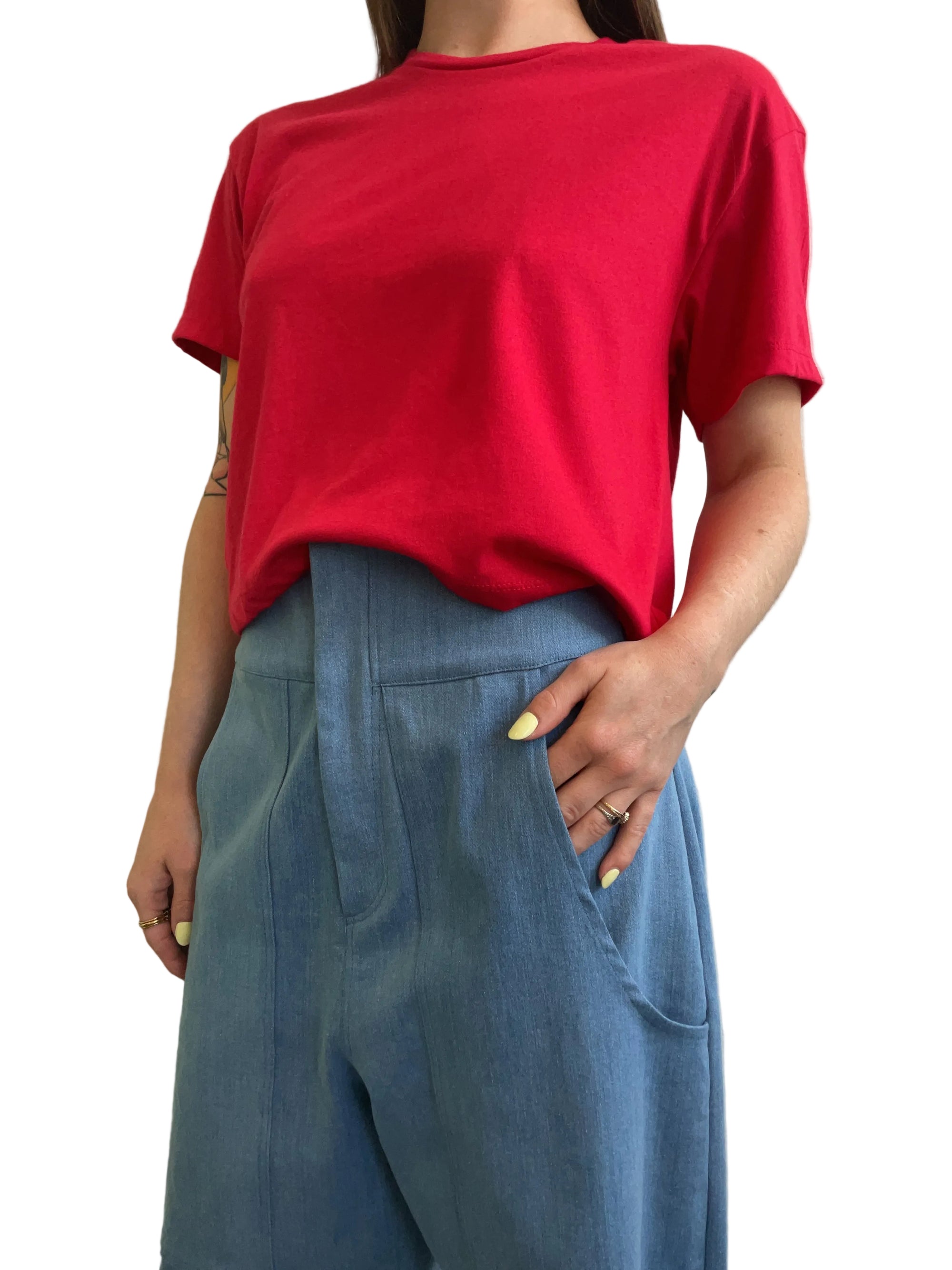 Person wearing a red shirt and blue pants on a plain background